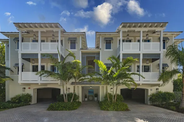 a front view of a multi story residential apartment building with a yard