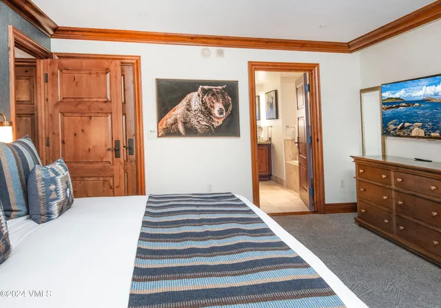 a bedroom with a bed and a dresser