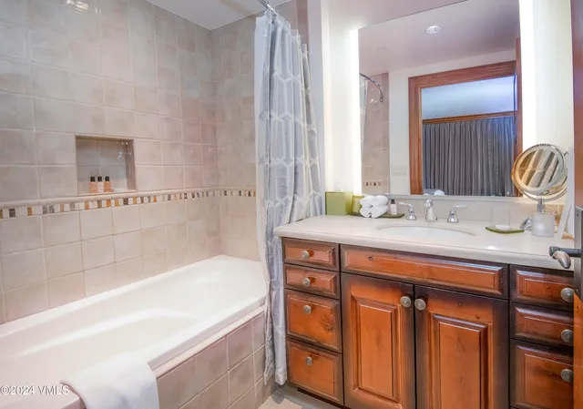 a bath room with a sink and a mirror