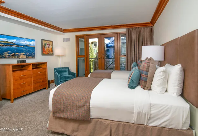 a bedroom with a large bed and a large window