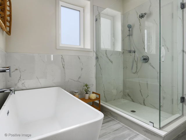 770 East Irving Park Road, Unit 3E Roselle, IL 60172 - Photo 15 of 17 a white bath tub sitting next to a shower