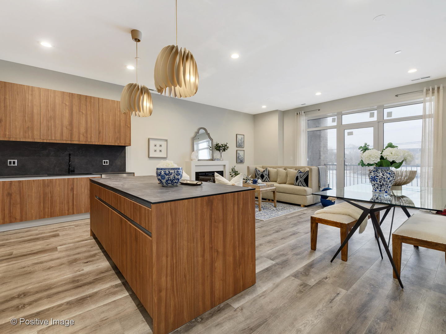 770 East Irving Park Road, Unit 3E Roselle, IL 60172 - Photo 3 of 17 a kitchen with stainless steel appliances granite countertop wooden cabinets a sink dishwasher a dining table and chairs with wooden floor