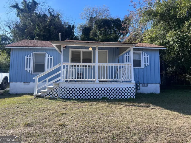 a front view of a house with a garden