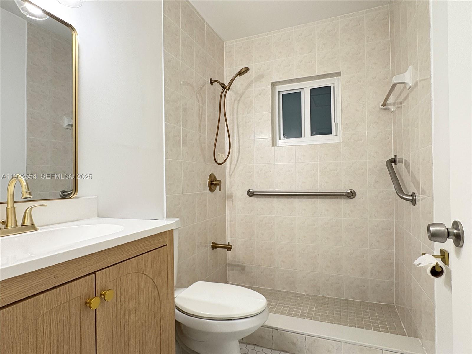 527 Southwest 9th Avenue, Unit 527 Miami, FL 33130 - Photo 15 of 34 a bathroom with a granite countertop sink toilet and shower