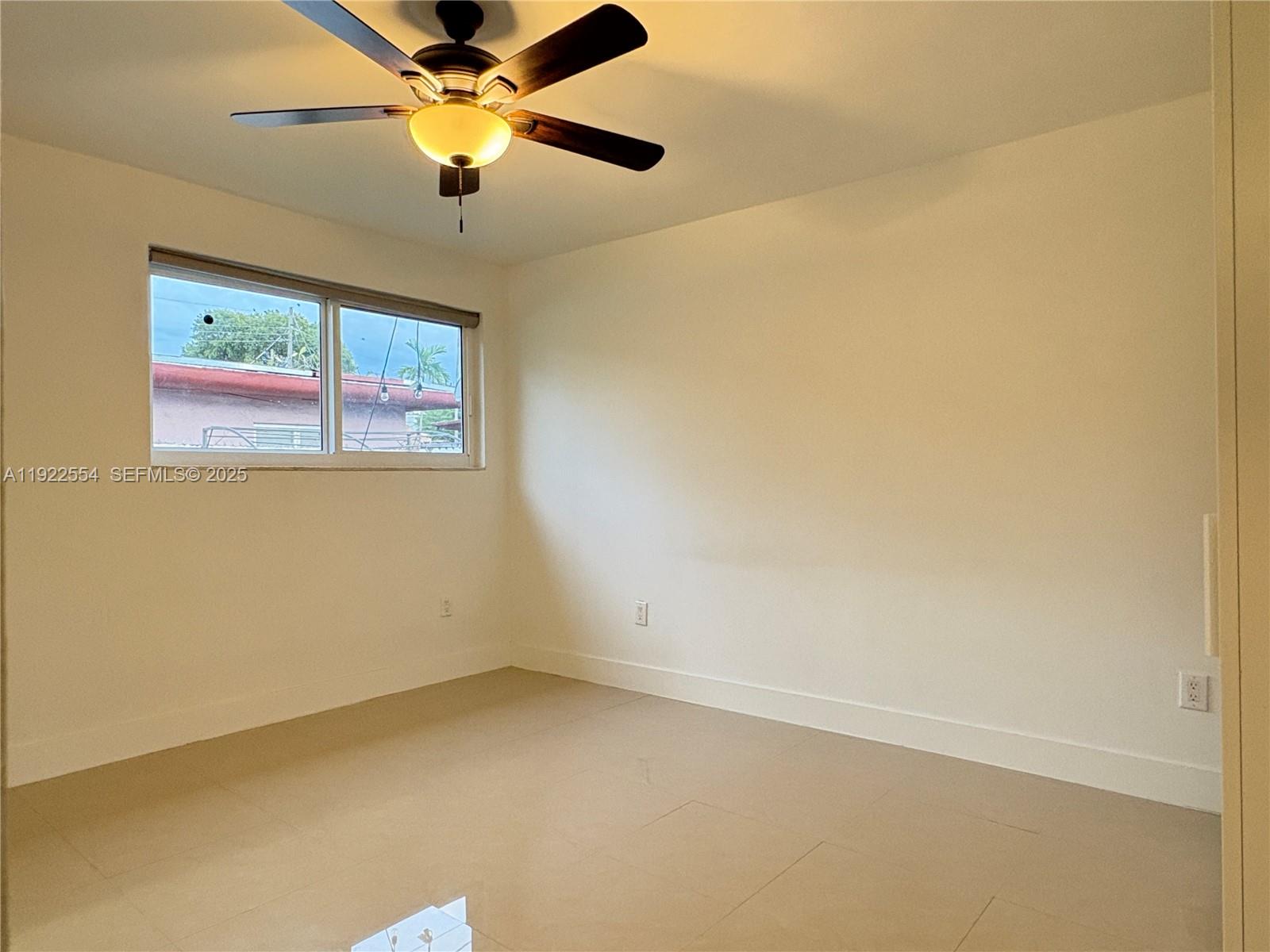 527 Southwest 9th Avenue, Unit 527 Miami, FL 33130 - Photo 20 of 34 an empty room with a window and a fan