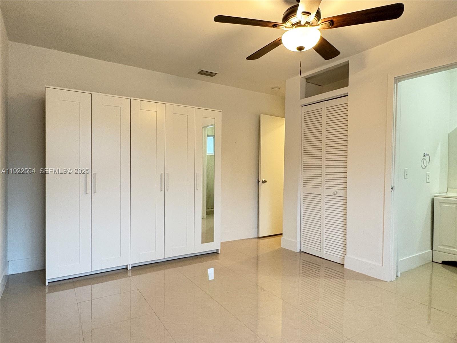 527 Southwest 9th Avenue, Unit 527 Miami, FL 33130 - Photo 21 of 34 a view of an empty room and chandelier fan