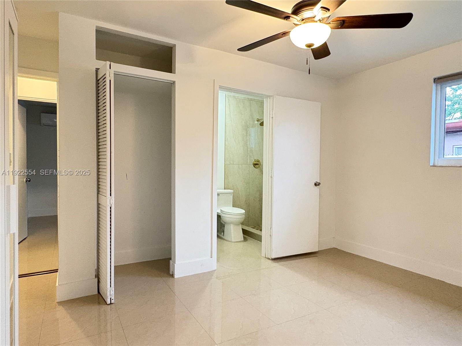 527 Southwest 9th Avenue, Unit 527 Miami, FL 33130 - Photo 22 of 34 wooden floor in an empty room and a bathroom