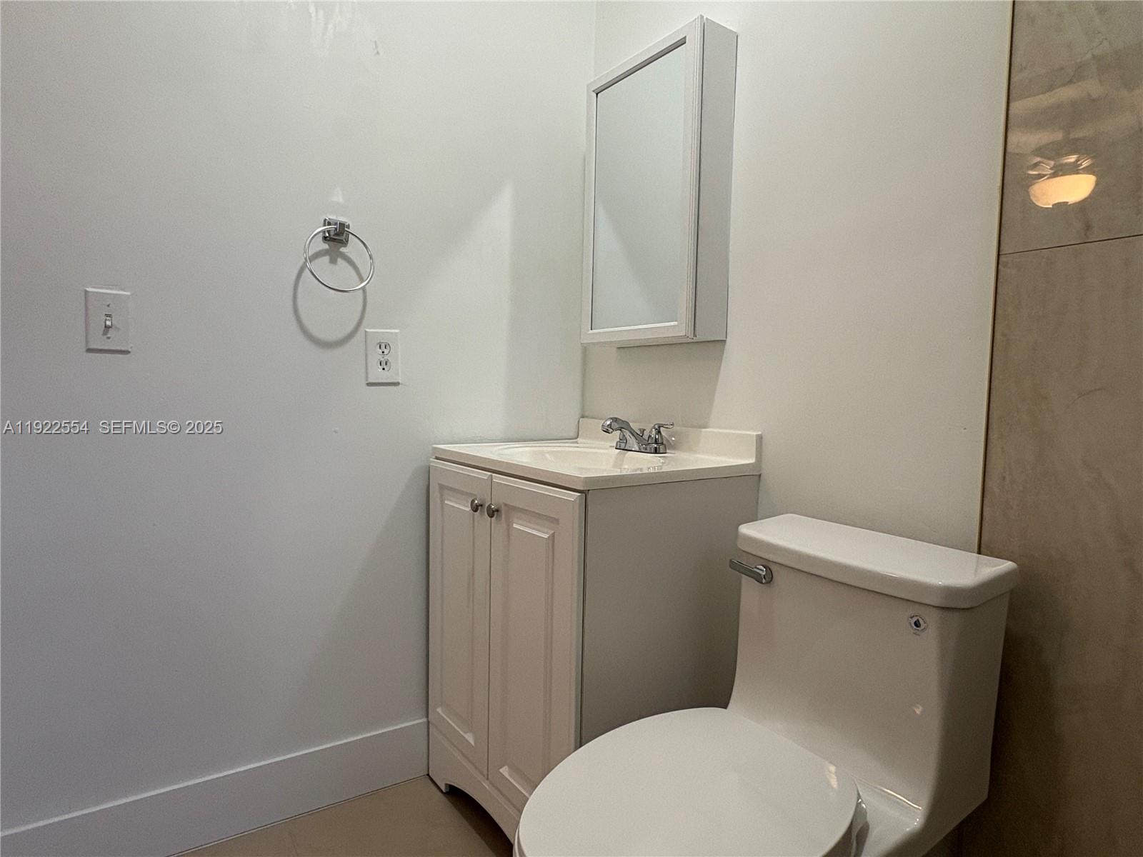 527 Southwest 9th Avenue, Unit 527 Miami, FL 33130 - Photo 24 of 34 a white toilet sitting next to a bathroom sink