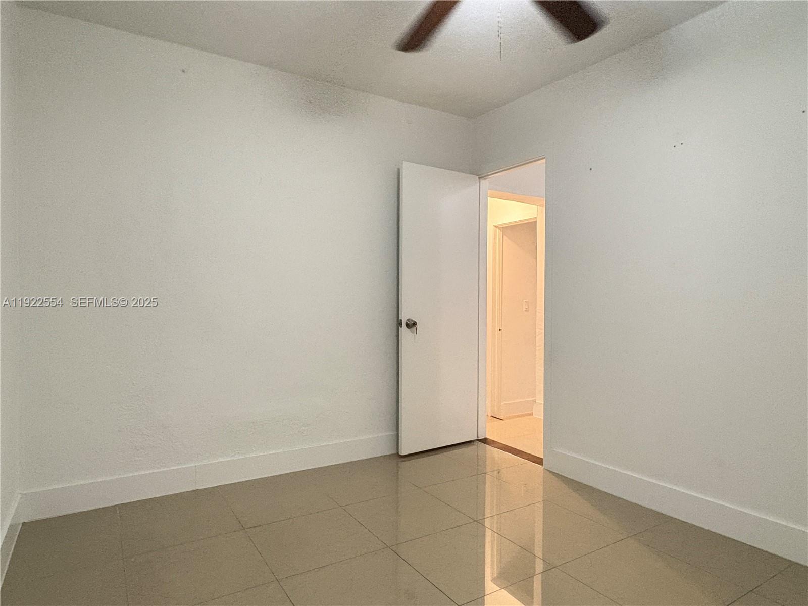 527 Southwest 9th Avenue, Unit 527 Miami, FL 33130 - Photo 29 of 34 an empty room with a empty space and chandelier fan