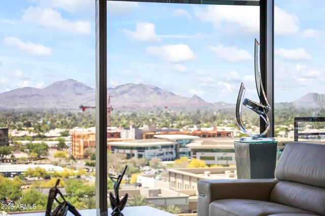 a living room with couches coffee table and a flat screen tv