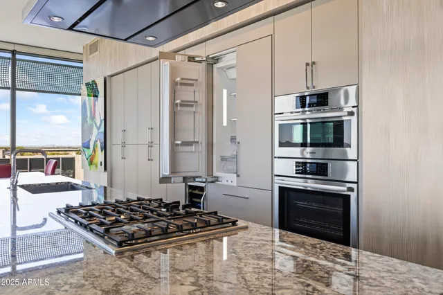 a bathroom with a granite countertop sink mirror and toilet