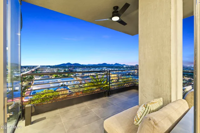 a dining room with furniture water view and a floor to ceiling window