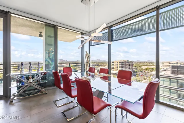 a living room with furniture a flat screen tv and a floor to ceiling window