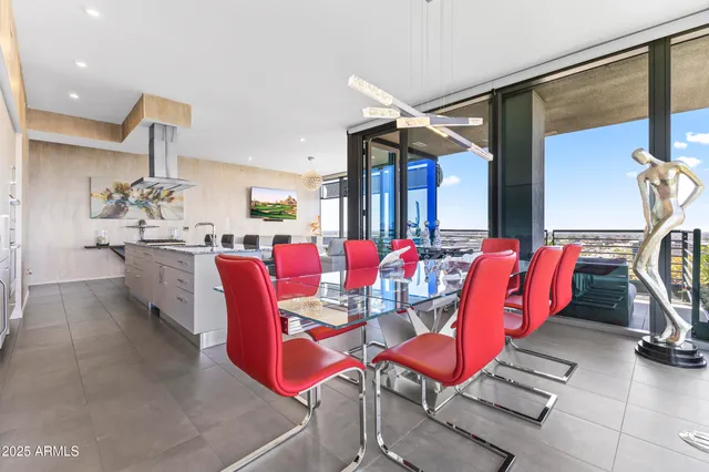 a living room with furniture a window and a flat screen tv