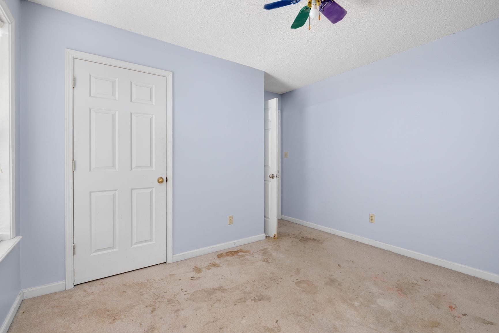 275 Morris Road Covington, TN 38019 - Photo 32 of 32 Unfurnished bedroom with light carpet, a textured ceiling, and ceiling fan