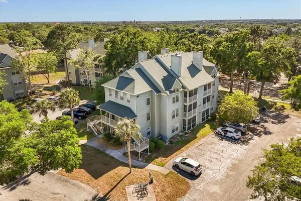 an aerial view of a house with a yard