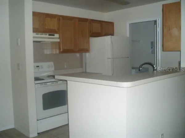 a kitchen with a sink and a refrigerator