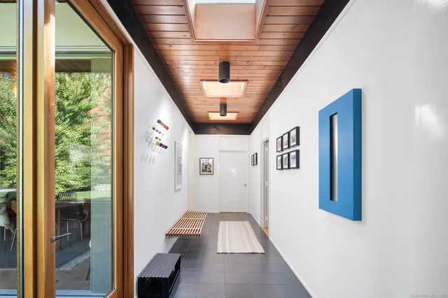 a hallway with wooden floor windows and entryway