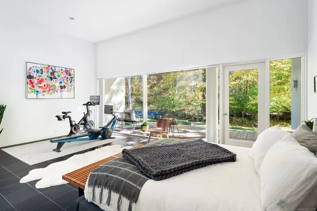 a bed room with a bed and a chair