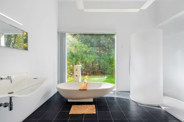 a room with pool table and windows