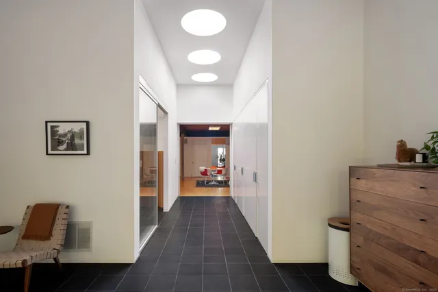 a view of a hallway to a livingroom and a couch