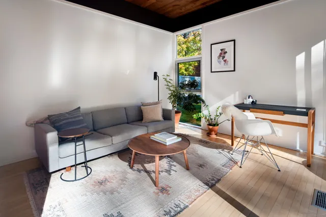 a living room with furniture and wooden floor