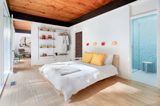 a bedroom with a large bed and a large window