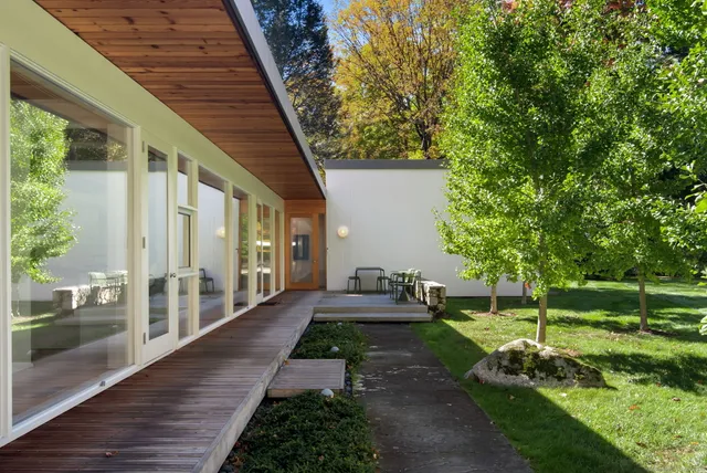 a view of a house with backyard and sitting area