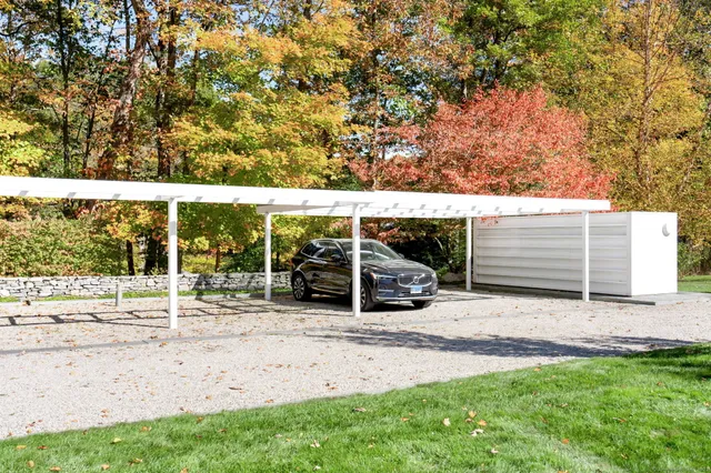 a view of a chairs and table in backyard