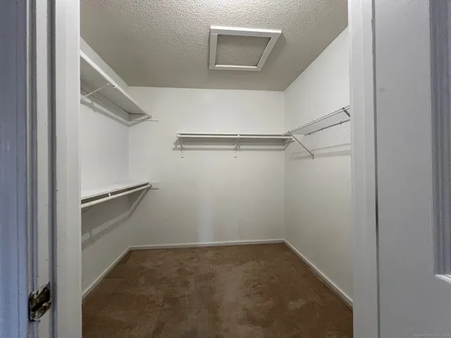a view of a balcony with two chairs and a potted plant
