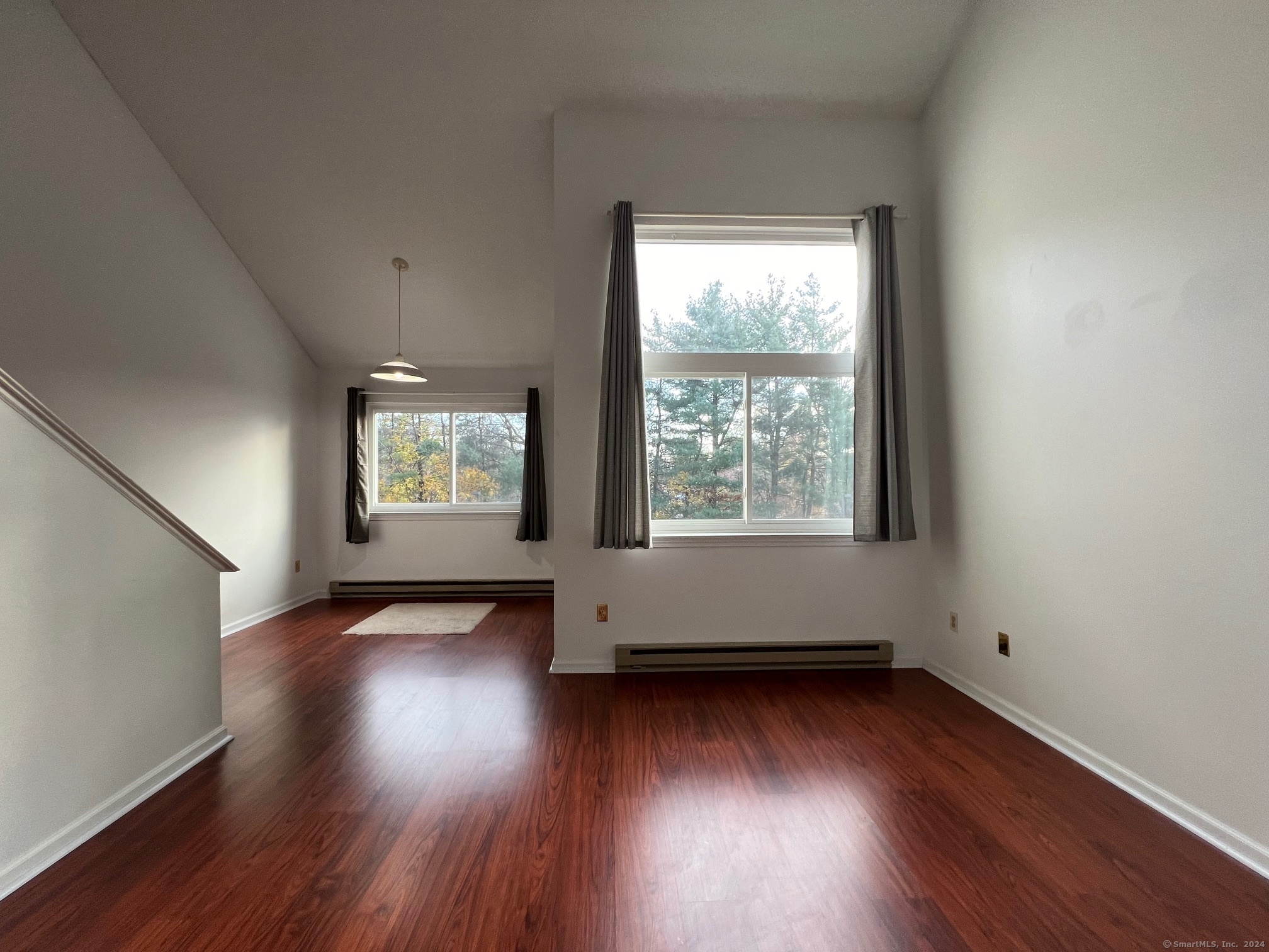 35 Ruth Street, Unit 66 Bristol, CT 06010 - Photo 7 of 17 an empty room with wooden floor and windows