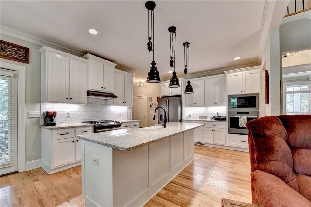 919 Fields Chapel Road Canton, GA 30114 - Photo 12 of 58 a large kitchen with stainless steel appliances granite countertop a stove a sink a refrigerator and white cabinets
