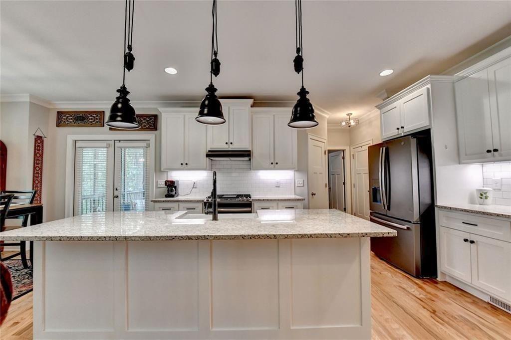 919 Fields Chapel Road Canton, GA 30114 - Photo 13 of 58 a kitchen with stainless steel appliances granite countertop a sink a stove and a refrigerator