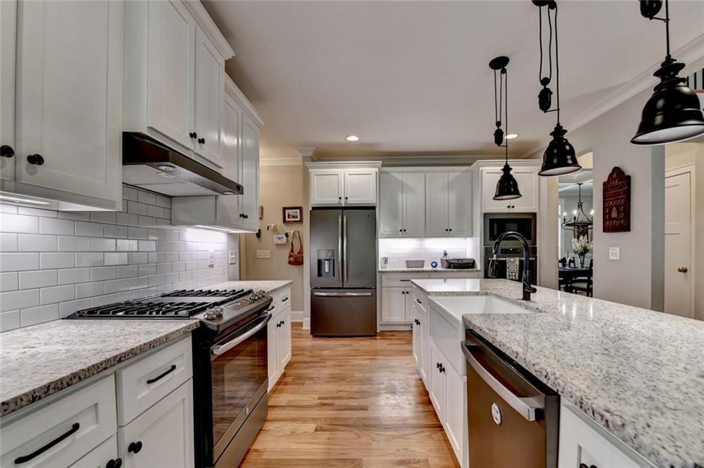 919 Fields Chapel Road Canton, GA 30114 - Photo 14 of 58 a kitchen with stainless steel appliances granite countertop a sink stove and refrigerator