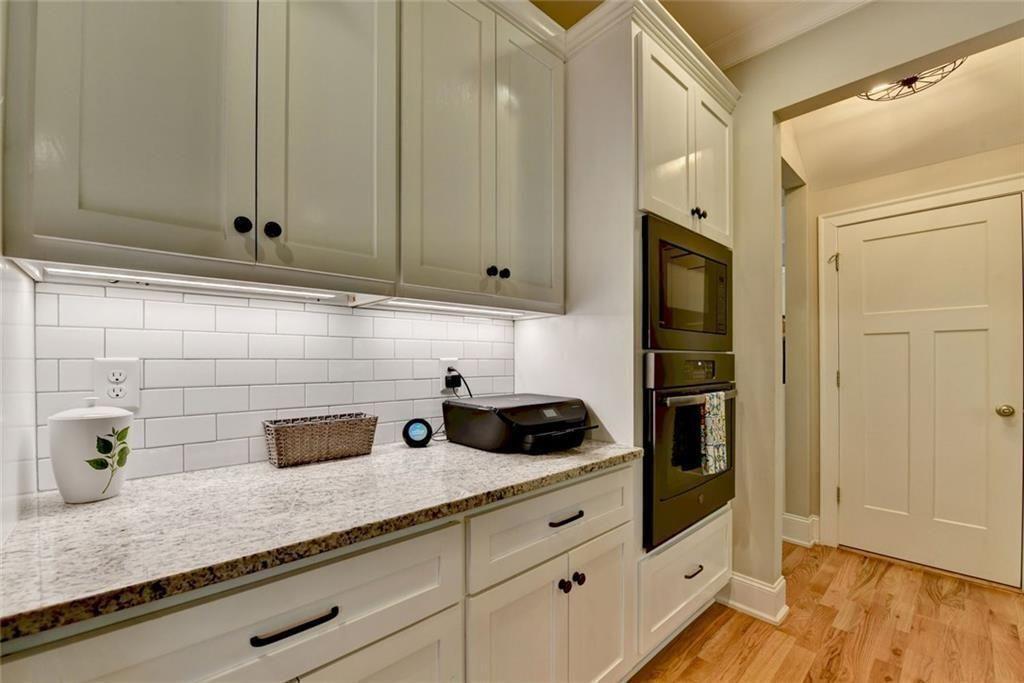 919 Fields Chapel Road Canton, GA 30114 - Photo 15 of 58 a kitchen with granite countertop white cabinets and stainless steel appliances