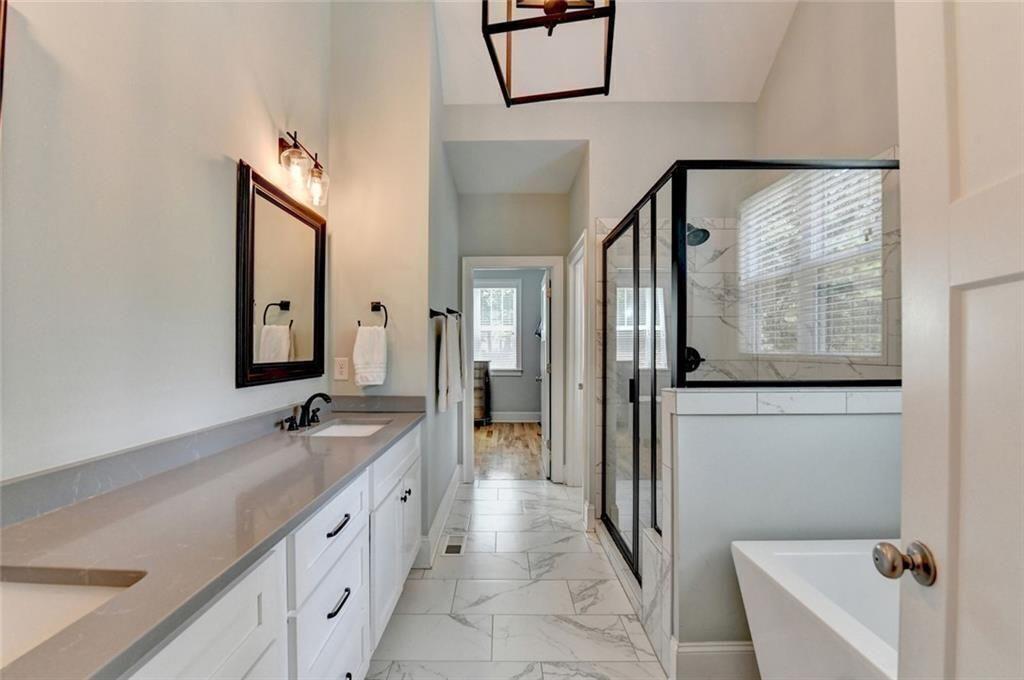 919 Fields Chapel Road Canton, GA 30114 - Photo 28 of 58 a spacious bathroom with a granite countertop tub sink and mirror