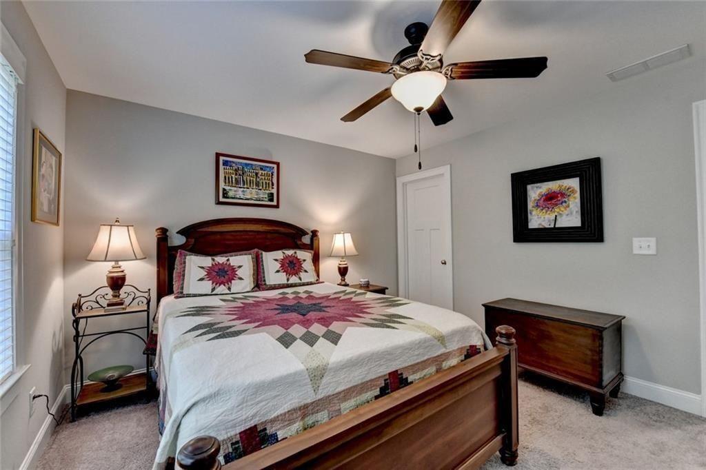 919 Fields Chapel Road Canton, GA 30114 - Photo 34 of 58 a bedroom with a bed and a chandelier