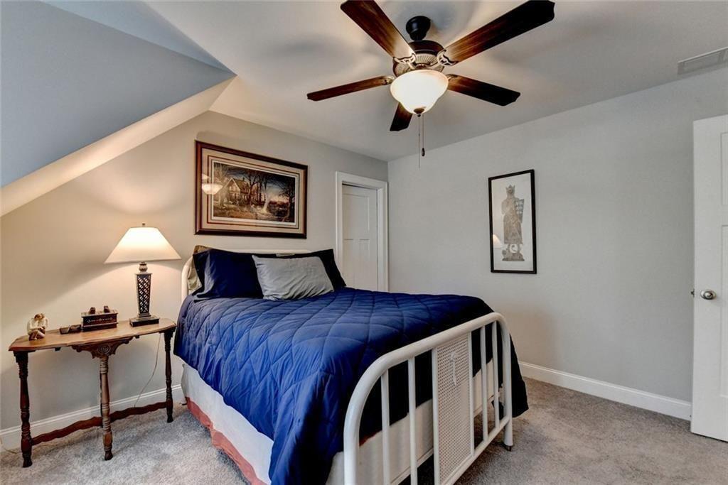 919 Fields Chapel Road Canton, GA 30114 - Photo 40 of 58 a bedroom with a bed and a chandelier