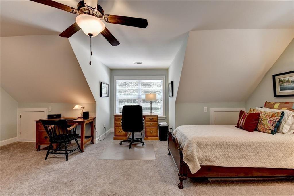 919 Fields Chapel Road Canton, GA 30114 - Photo 43 of 58 a bedroom with a bed a desk and chair with the potted plants