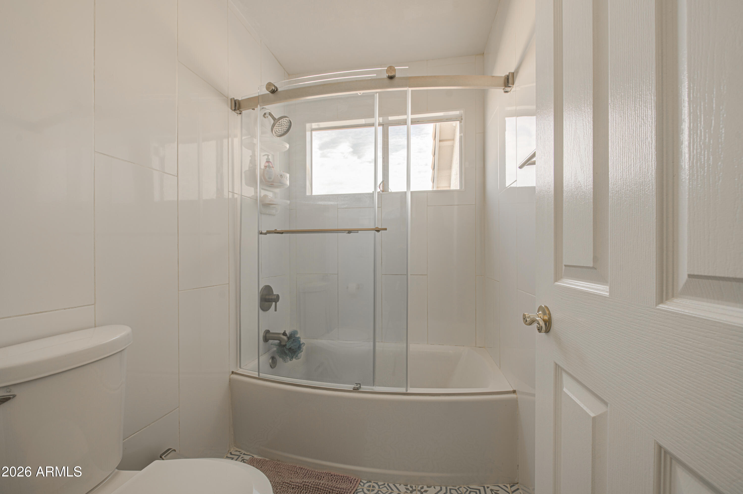 12403 West Monte Vista Road Avondale, AZ 85392 - Photo 45 of 63 a bathroom with a shower a toilet and a window