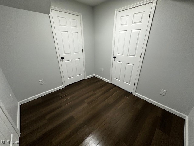 9109 Johnnycake Ridge Road Mentor, OH 44060 - Photo 23 of 28 Unfurnished bedroom featuring dark wood-style flooring and baseboards