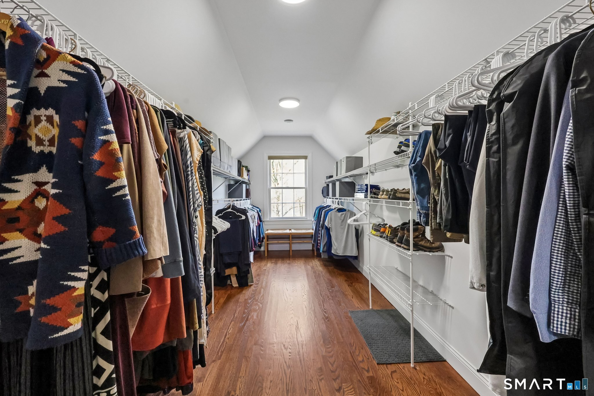 3 East Lake Road Danbury, CT 06811 - Photo 24 of 37 The walk-in closet features hardwood floors and generous space, offering a well-organized and functional layout for effortless living.
