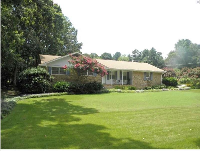 Classic EXPANDED ranch on a level corner lot with .7 acres has nice curb appeal.  Side entry garage and one step to kitchen level.  Four sides BRICK.  Quiet setting.  Don't let the main street fool you.  It is quiet.
