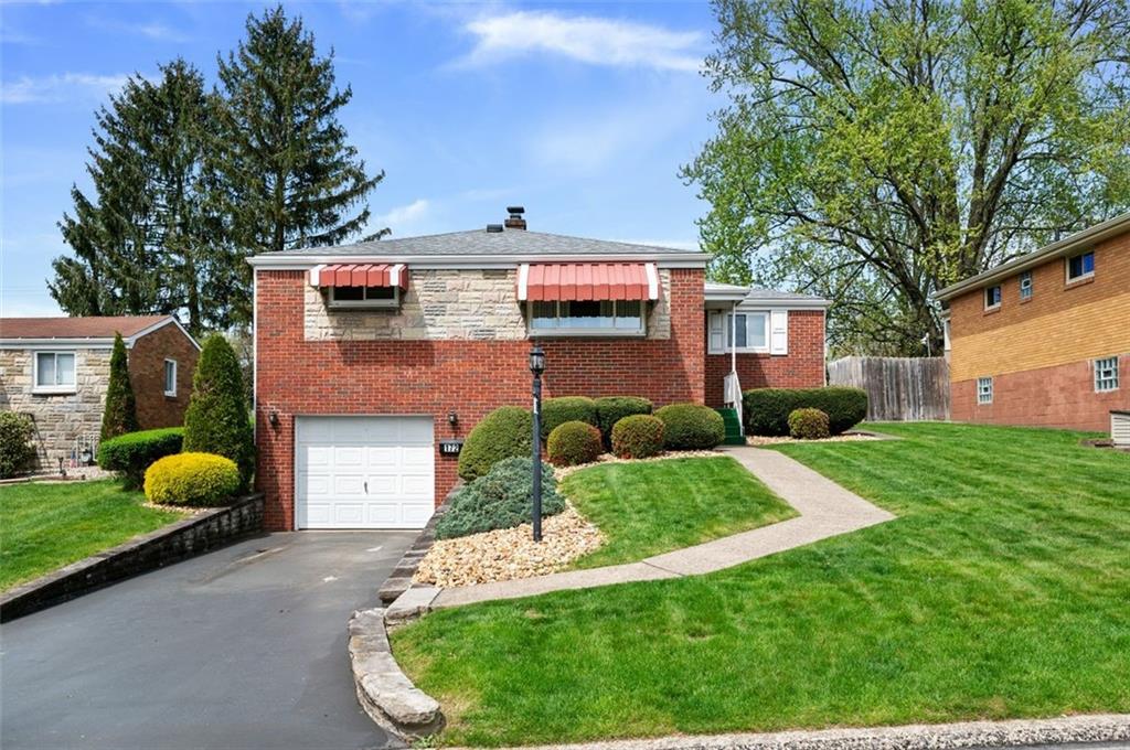 a view of a house with a backyard and a garden