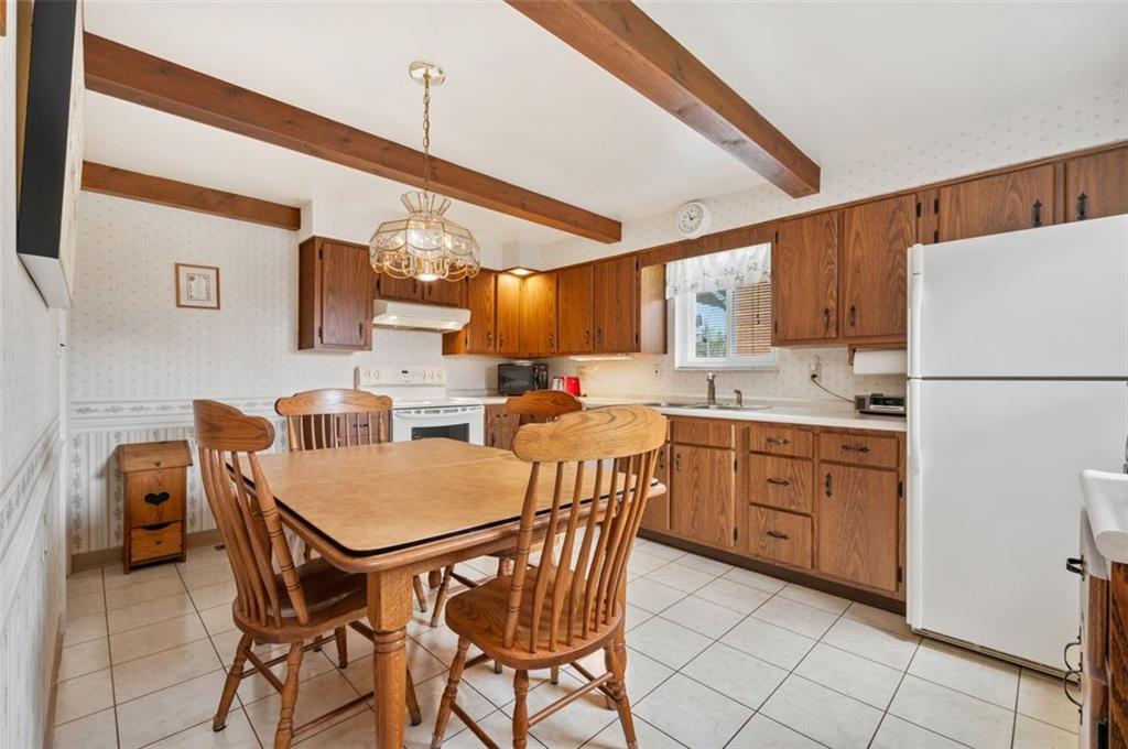 172 Eileen Drive Pittsburgh, PA 15227 - Photo 2 of 21 a kitchen with stainless steel appliances granite countertop a stove a sink dishwasher and a refrigerator with wooden cabinets