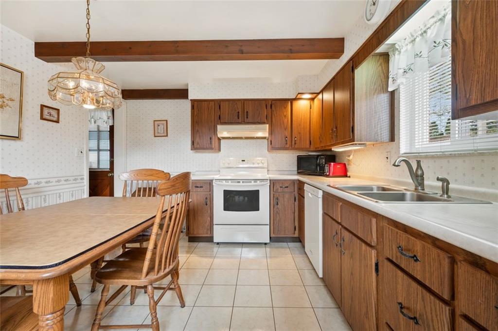 172 Eileen Drive Pittsburgh, PA 15227 - Photo 3 of 21 a kitchen with a table chairs sink and cabinets