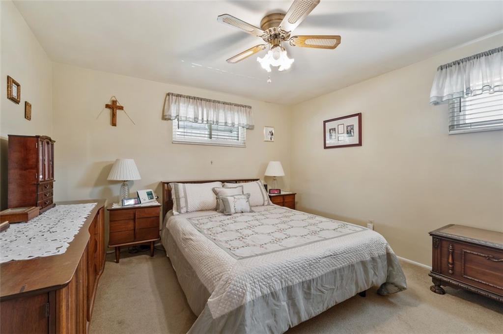 172 Eileen Drive Pittsburgh, PA 15227 - Photo 8 of 21 a bedroom with a bed and a chandelier