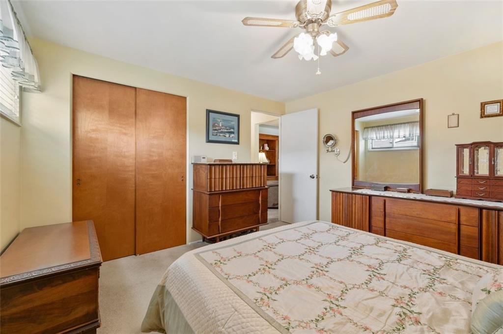 172 Eileen Drive Pittsburgh, PA 15227 - Photo 10 of 21 a bedroom with a large bed and a chandelier