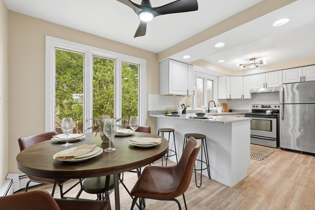 75 North Road Hampden, MA 01036 - Photo 11 of 42 a kitchen with a dining table chairs and refrigerator