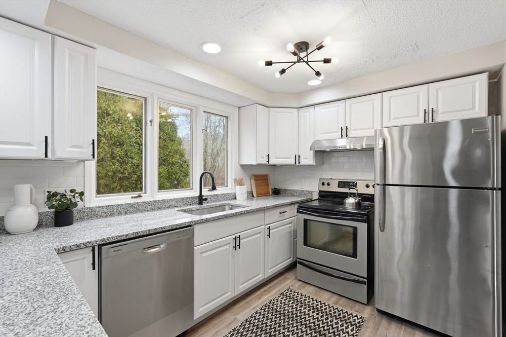 75 North Road Hampden, MA 01036 - Photo 15 of 42 a kitchen with a sink stainless steel appliances white cabinets and a window